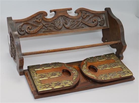 A victorian brass mounted rosewood book slide and a carved oak book rack